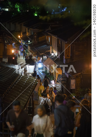 Kyoto, Japan - Sep 23 2024, vertical view of the ancient street on the mountainside in Gion district, at night, with many people strolling, Kyoto, Japan Kyoto, Japan - Sep 23 2024, vertical view of the ancient street on the mountainside in Gion district, at night, with many people strolling, Kyoto, Japan 140198030