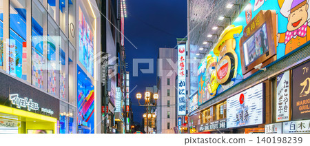 Osaka, Japan - Sep 22 2024, Panoramic view of Dotonbori street with various cafes, restaurants, bright signs and advertisements, illumination, a lot of people walking, at night, Osaka, Japan Osaka, Japan - Sep 22 2024, Panoramic view of Dotonbori street with various cafes, restaurants, bright signs and advertisements, illumination, a lot of people walking, at night, Osaka, Japan 140198239