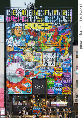 Osaka, Japan - Sep 22 2024, panoramic view of the facade of hotel building completely covered with a variety of graffiti and street art, on corniche of Dotonbori Canal, at nighttime, Osaka, Japan Osaka, Japan - Sep 22 2024, panoramic view of the facade of hotel building completely covered with a variety of graffiti and street art, on corniche of Dotonbori Canal, at nighttime, Osaka, Japan 140198241