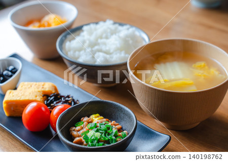 A Japanese breakfast consisting of steaming hot white rice, miso soup, and natto. A Japanese breakfast consisting of steaming hot white rice, miso soup, and natto. 140198762