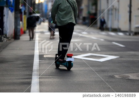 Image of an electric kickboard running on the road Image of an electric kickboard running on the road 140198889