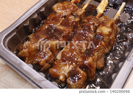 Glistening Skewered Meat in Tray 140200098
