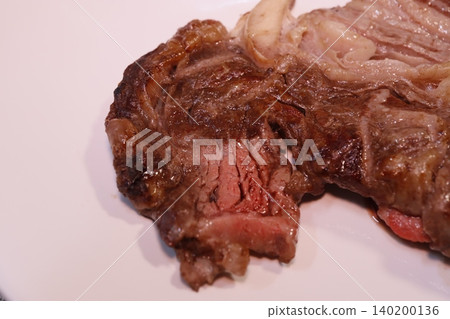 Medium-Rare Steak with Fat Marbling on Plate Medium-Rare Steak with Fat Marbling on Plate 140200136