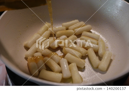 Syrup Drizzled Over Cooking Rice Cakes in Pan 140200137
