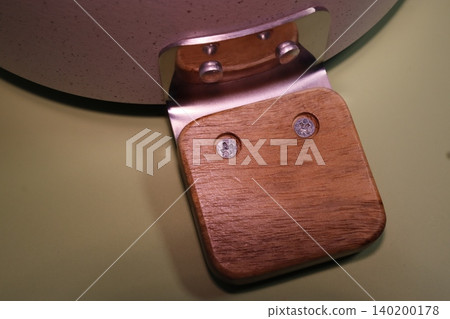 Wooden Handle Attached to Metal Component Close-up Wooden Handle Attached to Metal Component Close-up 140200178