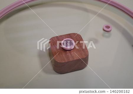 Wooden Block with Pink Button and Ring on Surface Wooden Block with Pink Button and Ring on Surface 140200182