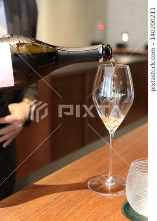 Wine Being Poured into Glass Wine Being Poured into Glass 140200211