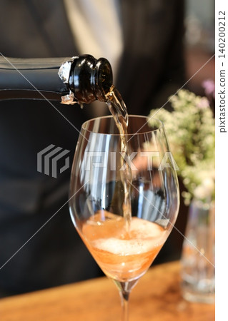 Pouring Sparkling Wine into Glass 140200212