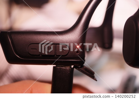 Wireless Earbud Control Module Close-up Wireless Earbud Control Module Close-up 140200252