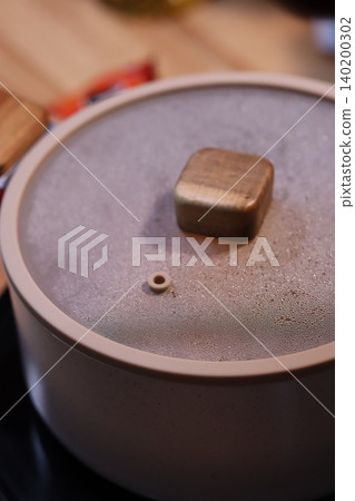 Close-up of a Pot Lid with Knob and Vent Hole Close-up of a Pot Lid with Knob and Vent Hole 140200302