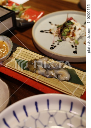 Japanese Cuisine Plating with Sea Urchin and Garnishes Japanese Cuisine Plating with Sea Urchin and Garnishes 140200533