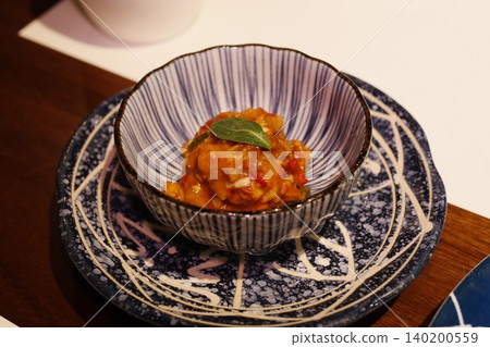 Artisanal Dish in Ceramic Bowl on Decorative Plate Artisanal Dish in Ceramic Bowl on Decorative Plate 140200559