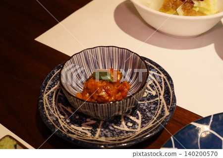 Delicate Dish with Sauce and Leaf on Ceramic Bowl 140200570