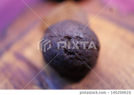 Close-up of Dark Chocolate Cookie on Wooden Surface Close-up of Dark Chocolate Cookie on Wooden Surface 140200628