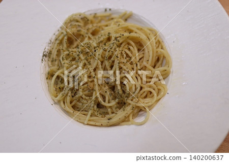 Herb-Topped Spaghetti on White Plate 140200637