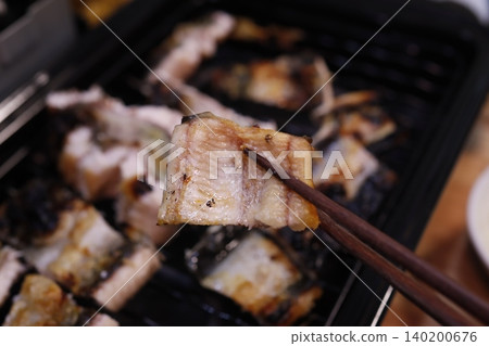 Grilled Fish on Grill with Chopsticks Grilled Fish on Grill with Chopsticks 140200676