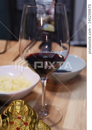 Wine Glass with Red Wine and Cheese Bowl Close-up Wine Glass with Red Wine and Cheese Bowl Close-up 140200678