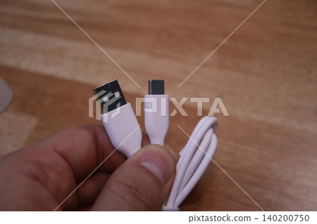 USB Cable with A and C Connectors Held in Hand USB Cable with A and C Connectors Held in Hand 140200750
