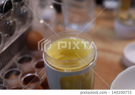 Jar of Beaten Eggs with Kitchen Items 140200755