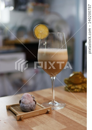 Cocktail with Lime Garnish and Wooden Board Detail Cocktail with Lime Garnish and Wooden Board Detail 140200787