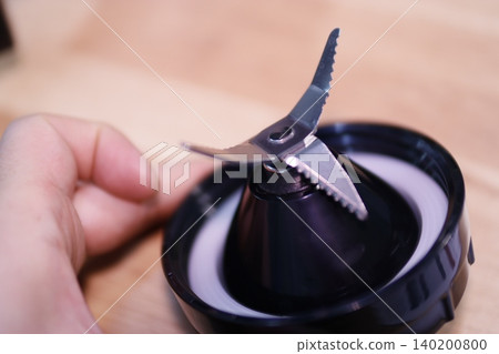 Close-up of Juicer Blade with Hand Holding 140200800