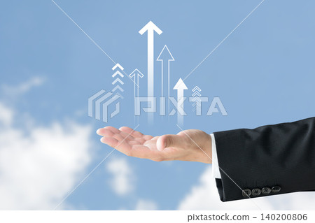 A businessman holding an upward-pointing arrow—symbolizing increased efficiency, productivity, and growth. A businessman holding an upward-pointing arrow—symbolizing increased efficiency, productivity, and growth. 140200806