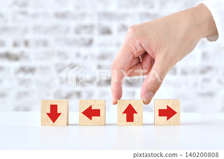 A hand choosing an upward-pointing arrow—an image of deciding on the future, the path, direction, and vision of one's life. A hand choosing an upward-pointing arrow—an image of deciding on the future, the path, direction, and vision of one's life. 140200808