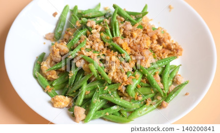 fried green bean with pork on white plate, thai and chinese food fried green bean with pork on white plate, thai and chinese food 140200841