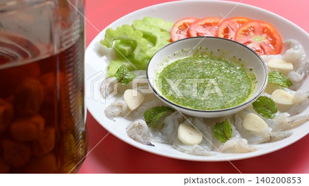 shrimp in fish sauce with Thai spicy seafood dipping sauce on white plate and umeshu shrimp in fish sauce with Thai spicy seafood dipping sauce on white plate and umeshu 140200853