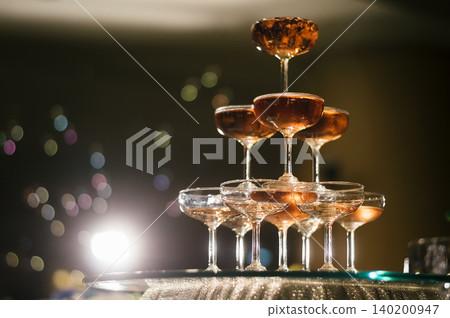 small tower of champagne's glass in wedding reception party 140200947
