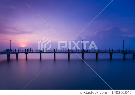 a view of a silhouette bridge across the blue sea in twilight scene a view of a silhouette bridge across the blue sea in twilight scene 140201043