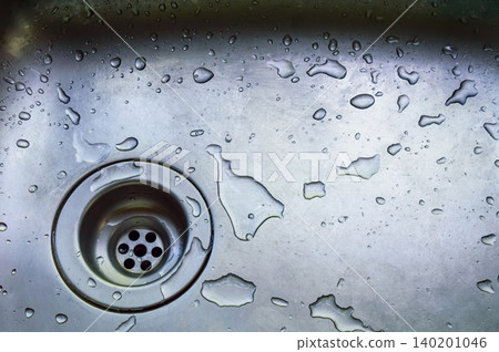 a wet dirty sink after washing many dishes a wet dirty sink after washing many dishes 140201046