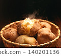 Potato with butter, steaming hot. 140201136