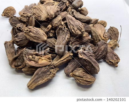 Pile of Dried Black Cardamom Pods, Whole black cardamom (Amomum subulatum) seed pods, an aromatic Indian spice Pile of Dried Black Cardamom Pods, Whole black cardamom (Amomum subulatum) seed pods, an aromatic Indian spice 140202101