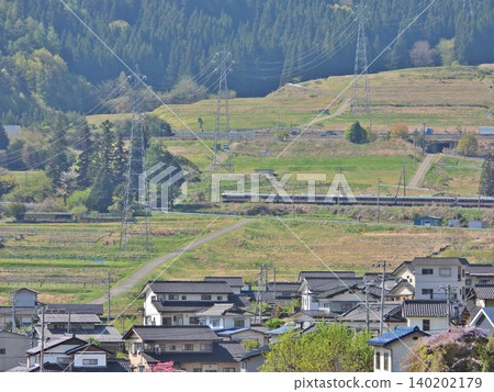 The Limited Express Shinano train runs through the terraced rice fields of the Yawata Nakahara district in Chikuma City. 140202179