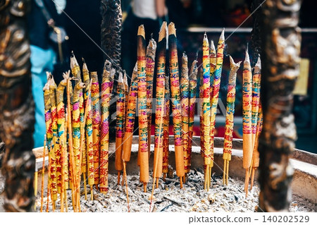Close up of burning colorful joss sticks with auspicious characters meaning blessing and peace at ancient a ma temple landmark in Macau China 140202529