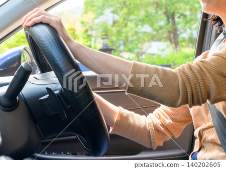 Female driver driving a car 140202605