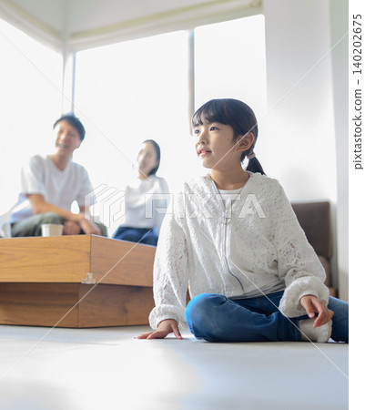 Girl sitting on the floor Girl sitting on the floor 140202675