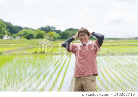 A farmer with his head in his hands. A farmer with his head in his hands. 140202719