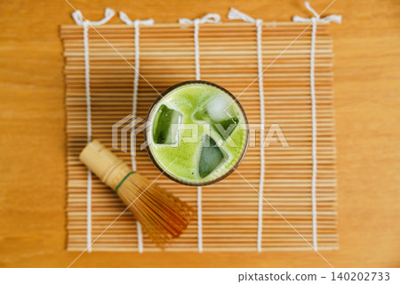 Top view of iced matcha green tea in glass on bamboo mat 140202733
