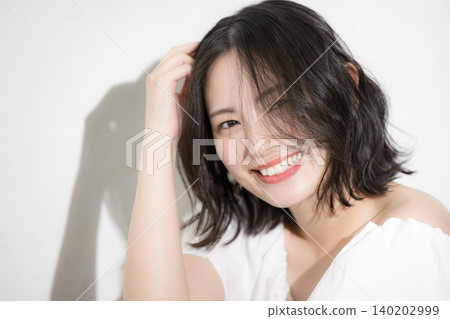 A natural beauty portrait of a cheerful and healthy woman with a charming, natural smile. A natural beauty portrait of a cheerful and healthy woman with a charming, natural smile. 140202999