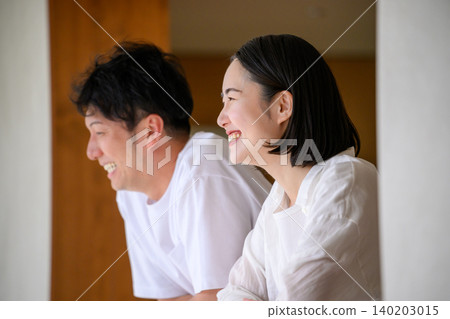Young couple cuddling with a smile 140203015
