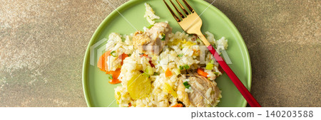 Boiled rice is served on a green plate alongside chicken breast, Brussels sprouts, and zucchini slices. A glass of water sits nearby, completing the meal, banner Boiled rice is served on a green plate alongside chicken breast, Brussels sprouts, and zucchini slices. A glass of water sits nearby, completing the meal, banner 140203588