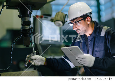 Mechanic Worker Hispanic Latin Indian male work service maintenance old Machine in metal plant 140203816