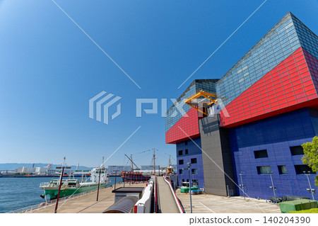 Osaka Port on a clear day, with the Osaka Aquarium Kaiyukan and cargo ships. Osaka Port on a clear day, with the Osaka Aquarium Kaiyukan and cargo ships. 140204390