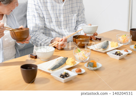 Senior couple eating at hand Senior couple eating at hand 140204531