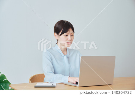 一位女士正在使用電腦尋找資訊。 140204722