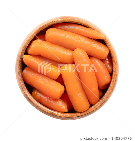 Whole baby carrots, conserved in water, in a wooden bowl. Canned small carrots, Daucus carota, offering a tender, slightly sweet flavor with bright orange color. Isolated, close-up, from above. Photo Whole baby carrots, conserved in water, in a wooden bowl. Canned small carrots, Daucus carota, offering a tender, slightly sweet flavor with bright orange color. Isolated, close-up, from above. Photo 140204776