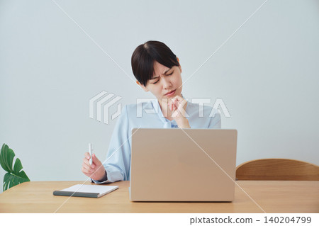 A woman working from home brainstorming work ideas A woman working from home brainstorming work ideas 140204799