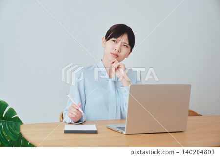 A woman working from home brainstorming work ideas A woman working from home brainstorming work ideas 140204801